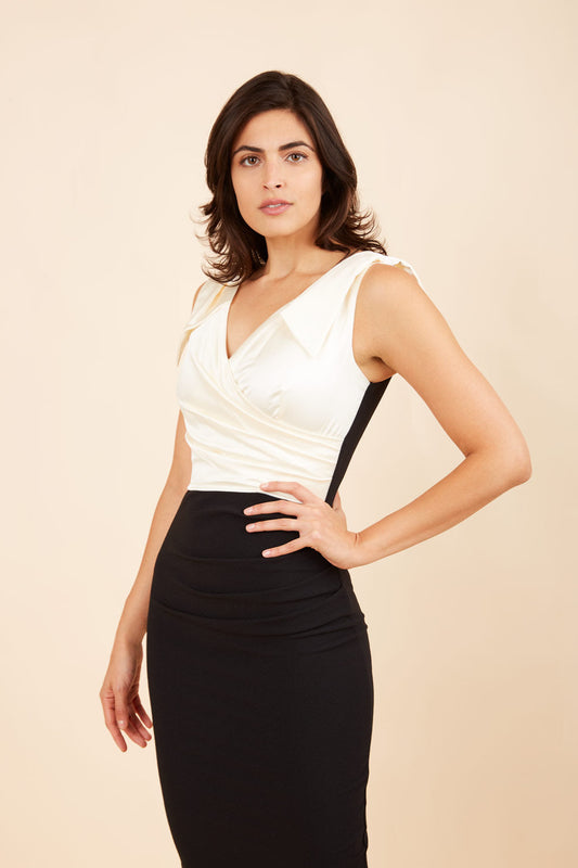 Model wearing the Diva Broadway Satin dress with satin bodice to front and pleating at the front in black and gardenia cream front image