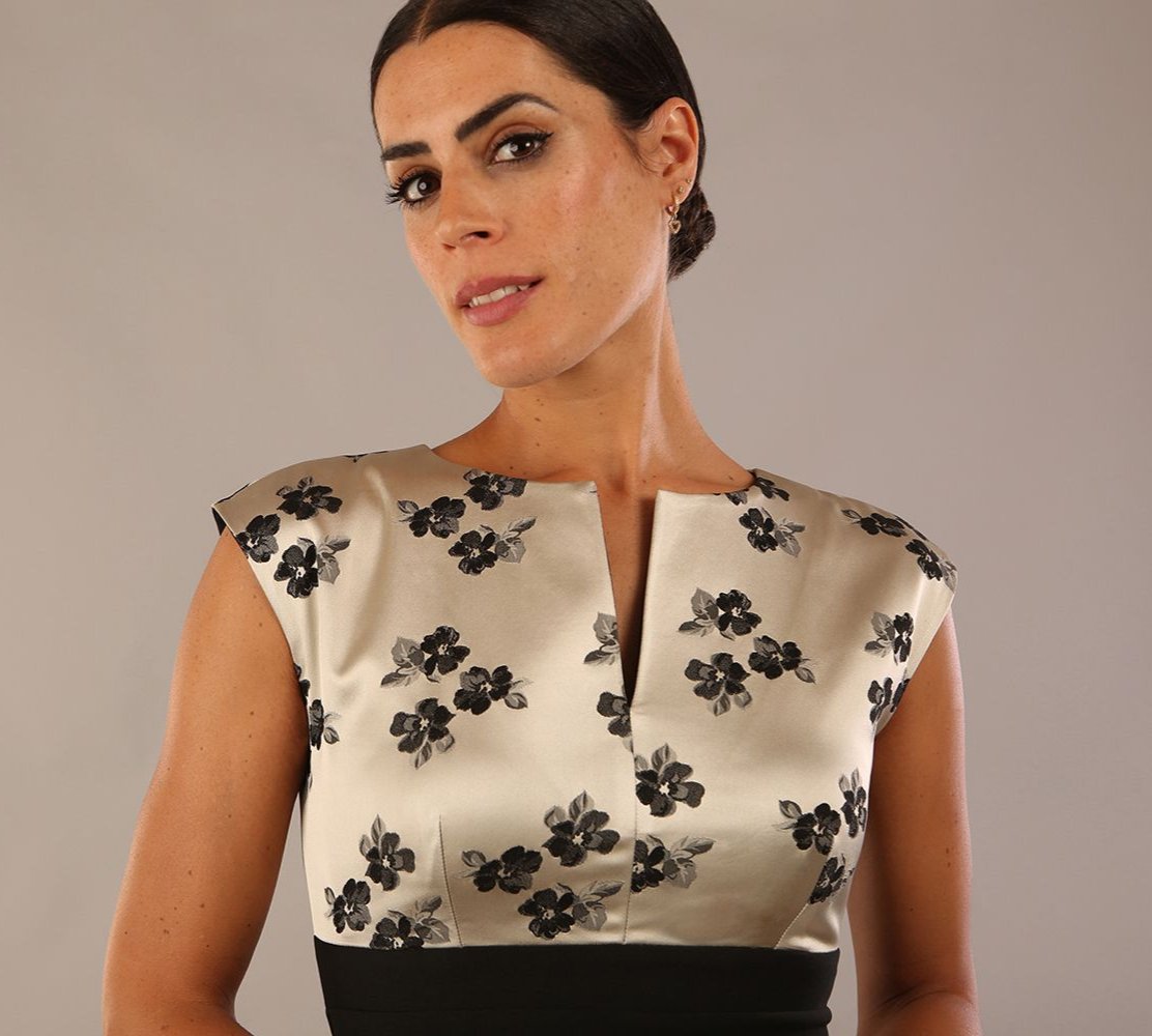 brunette model wearing diva catwalk dresses from england nadia colour block in black and champagne colours sleeveless dress front close up