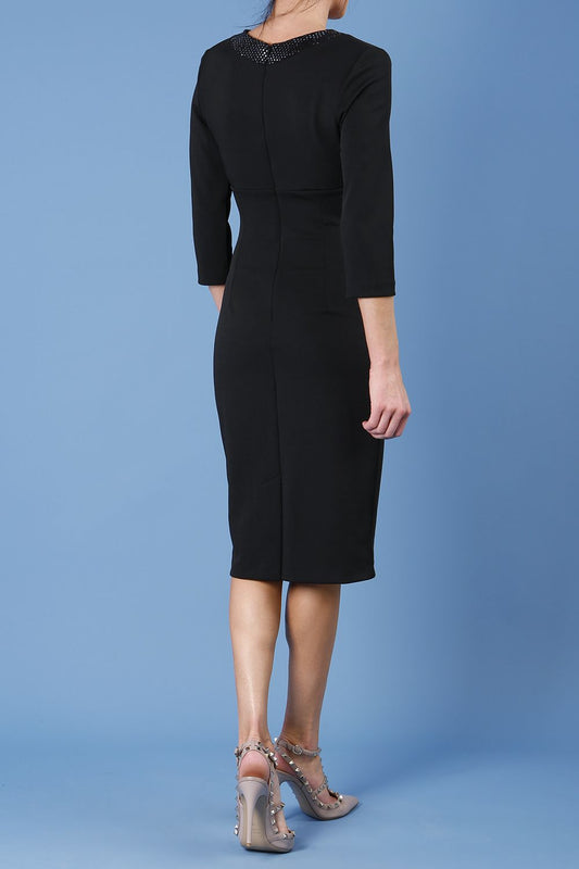 model is wearing diva catwalk sunset black pencil dress with contrasting slitter tie detail attached to the low v-neckliine front