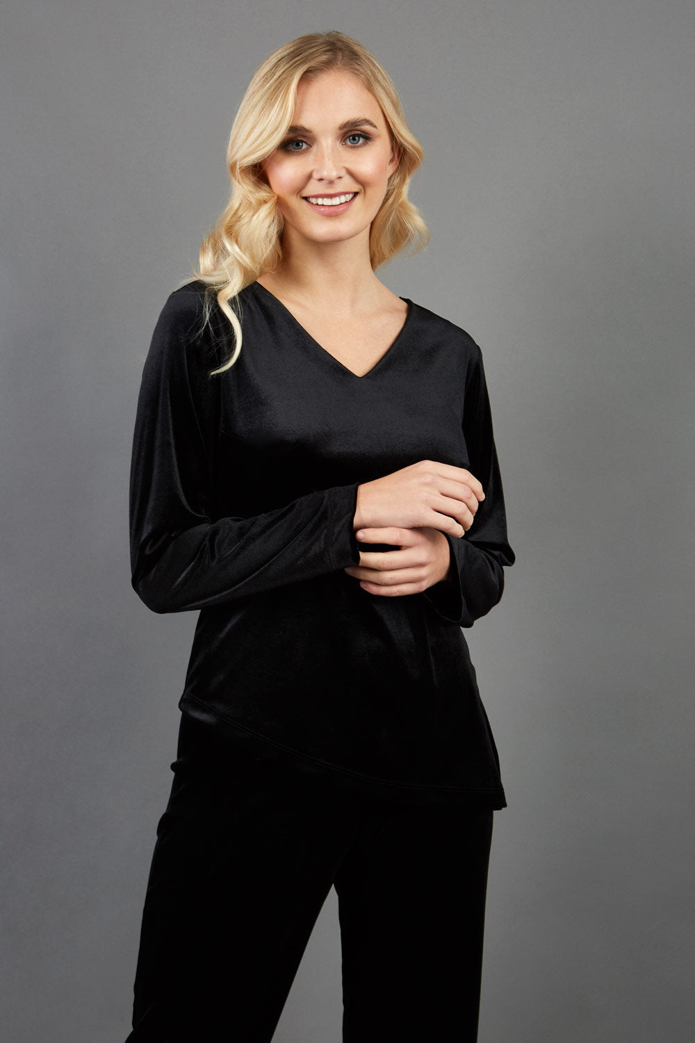 blonde model wearing diva catwalk dahlia asymmetric velvet top with sleeves in black front