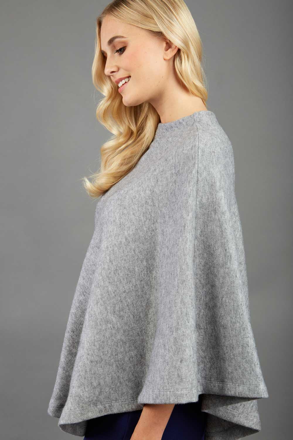 blonde model wearing diva catwalk rosalia poncho made in very cosy soft cashmere fabric in flint grey front