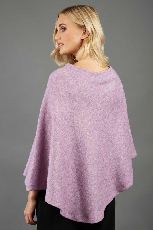 blonde model wearing diva catwalk rosalia poncho made in very cosy soft cashmere fabric in pale pink front