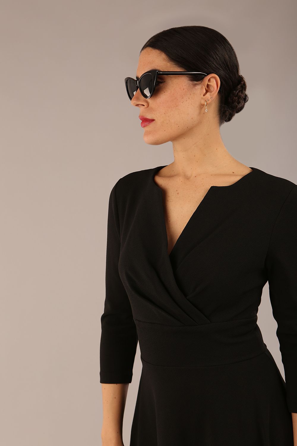 brunette model is wearing a diva catwalk january sleeved a-line swing v-neck dress in marvel fabric in black colour front close up