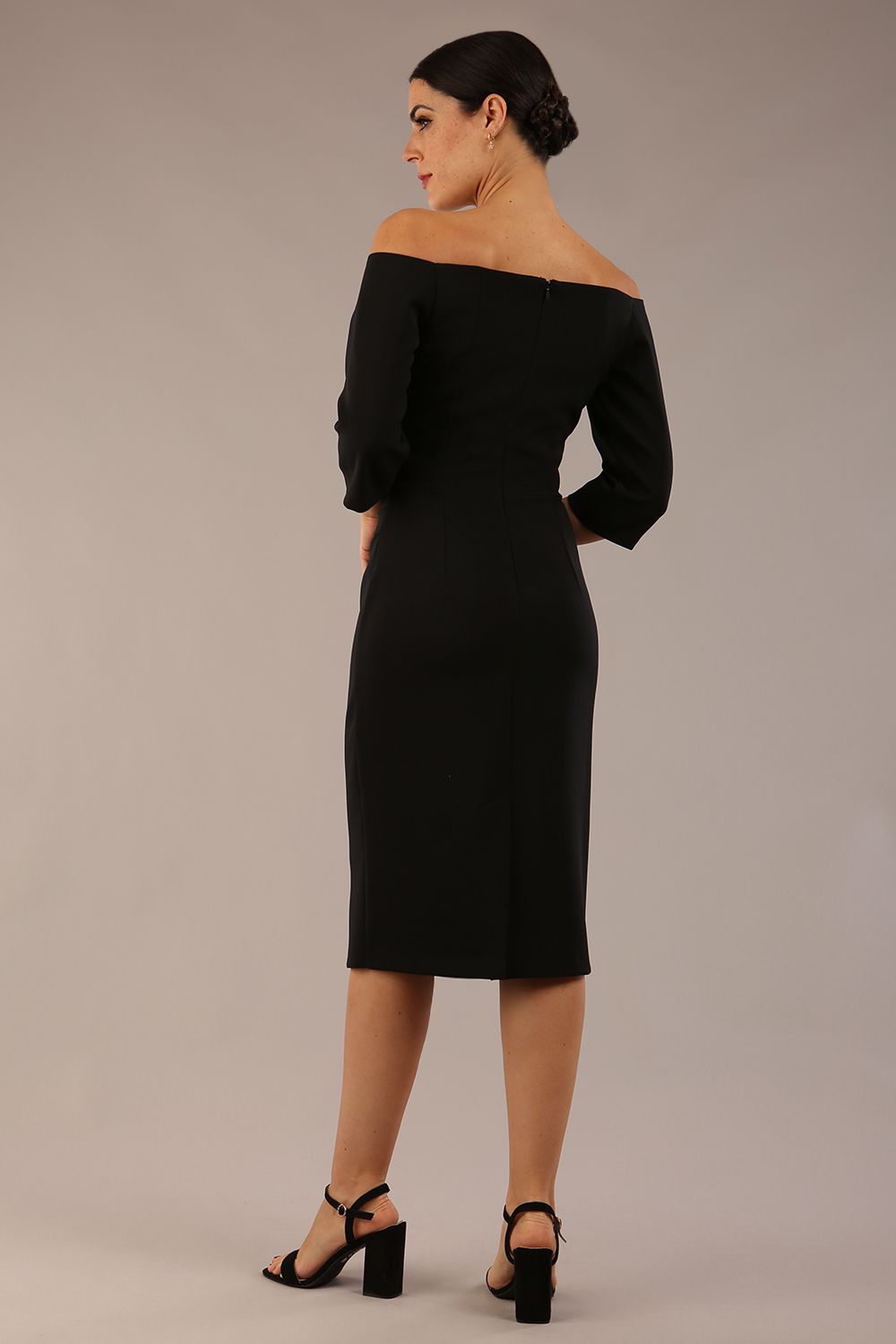 brunette model is wearing a diva catwalk lauren off shoulder asymmetric neckline pencil dress with sleeves in black front close up