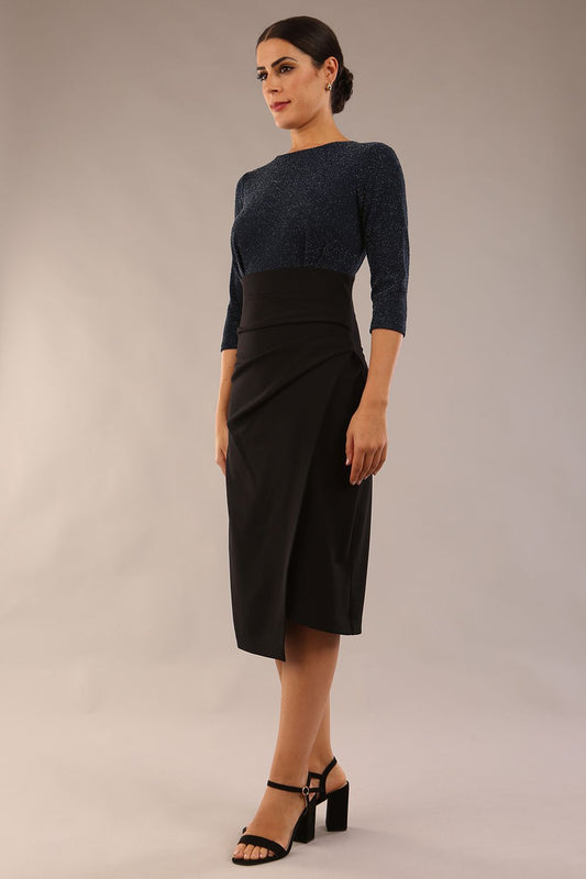 model is wearing diva catwalk contrast pencil dress with sleeve and assymetric skirt detail in black and teal sparkle front