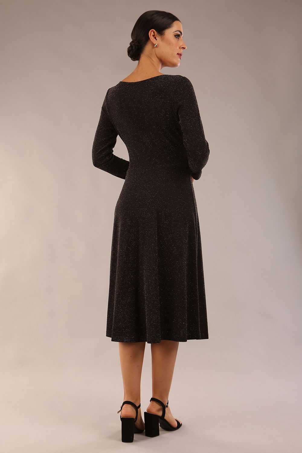 model is wearing diva catwalk westgate low v-neck wrapped swing skirt dress with long sleeves in black sparkle colour front