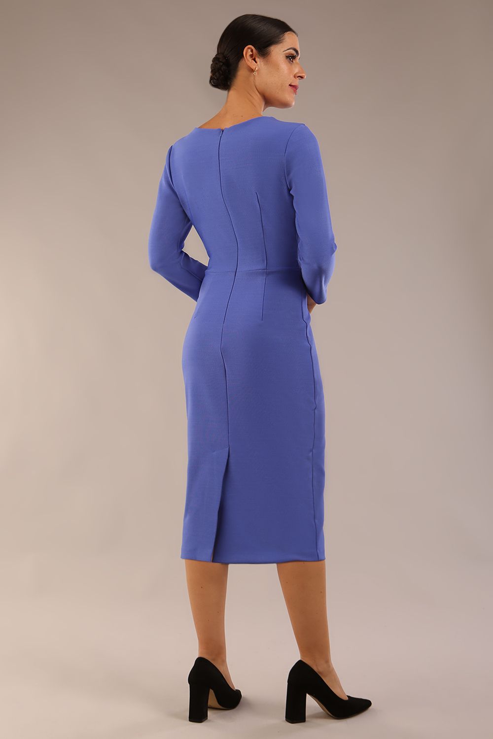 A woman modeling the diva catwalk SEED Dolores cascade ruffle pencil dress in thistle blue with a v-neckline and concealed zip at the back (Thistle blue)
