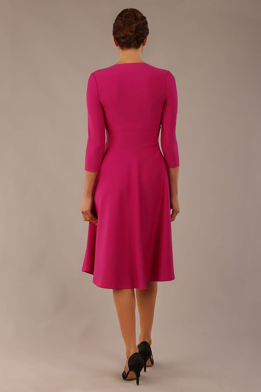 brunette model is wearing a diva catwalk Haddington sleeved A-line Dress knee length round neckline with crossover v-slit detail in magenta colour front image close up