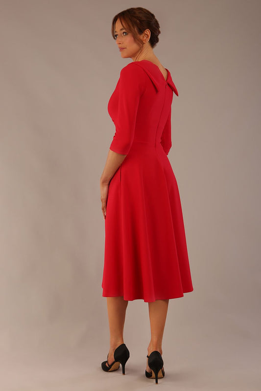 brunette model is wearing a diva catwalk Fabienne sleeved A-line Dress with pockets v neckline knee length wide waistband fold over v neckline in electric red colour front image (Electric Red)