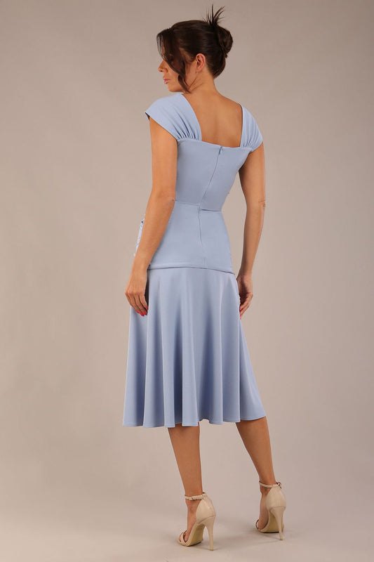 brunette model is wearing a diva catwalk Sonning Cap Sleeve Square Neckline A-Line midi Dress and rushing side details in powder blue colour front