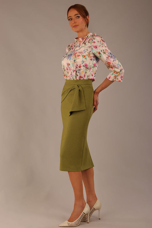 Model wearing the Rockwell 3/4 sleeve satin top in Lush Garden print, styled with an olive green pencil skirt (Lush Garden Satin Print)