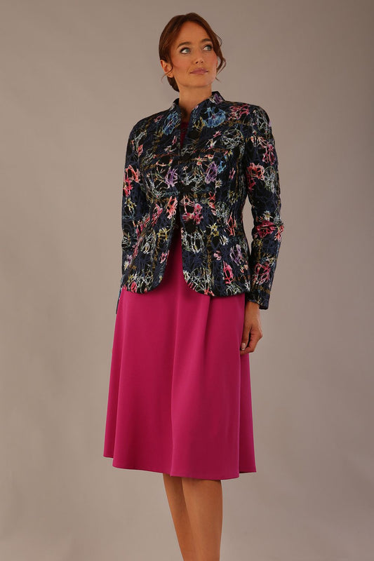 The Keanu floral jacket layered over a pink A-line dress for an elegant occasion look (Nightshade Bloom)