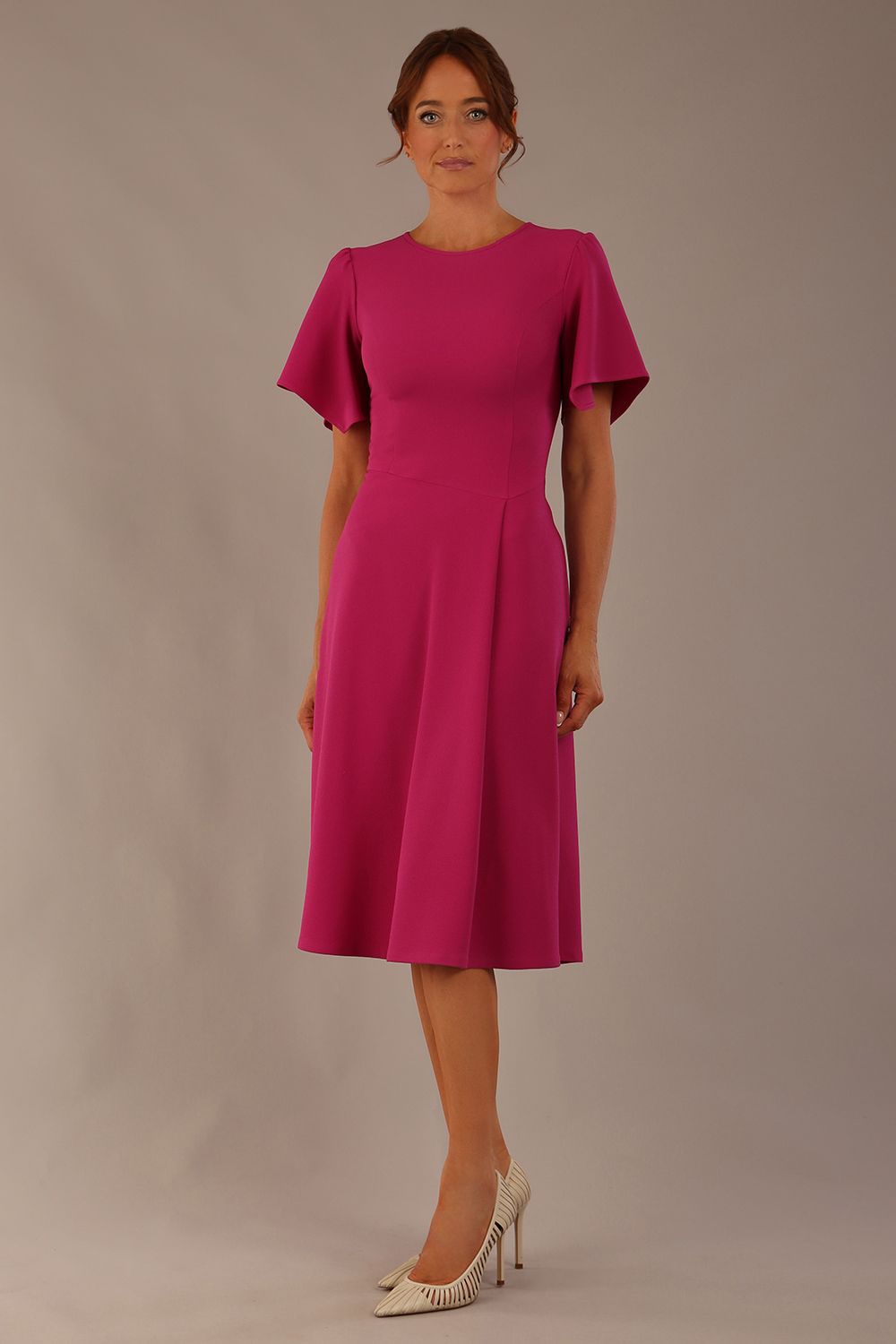 side view Model wearing a diva catwalk Anders petal sleeve A-line dress against a plain background (Magenta)