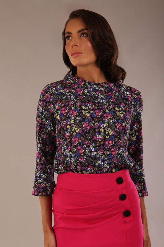 Model wearing the Elton 3/4 sleeve top in Blossom Jive print, styled with a fuchsia pencil skirt (Blossom Jive Print)