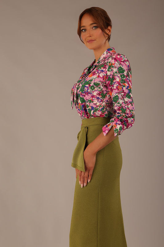 Model wearing a Radley Floral Tango print top with a central tie neckline and 3/4 sleeves, styled with an olive green skirt (Floral Tango)