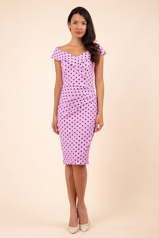 Brunette model wearing Diva Catwalk Fenella Polka Dot Pencil Sleeveless Dress off shoulder bardot neckline in pink back