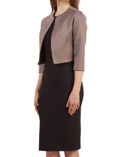 A model wearing a Weston Bond Bolero jacket in pink over a black dress. (Mist Pink)