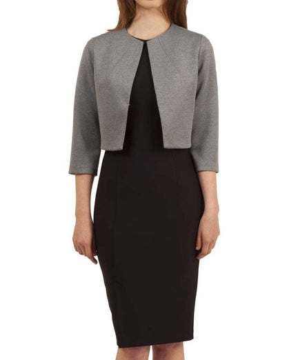 Woman wearing a black dress with a gray jacket on a beige background (Misty Grey)