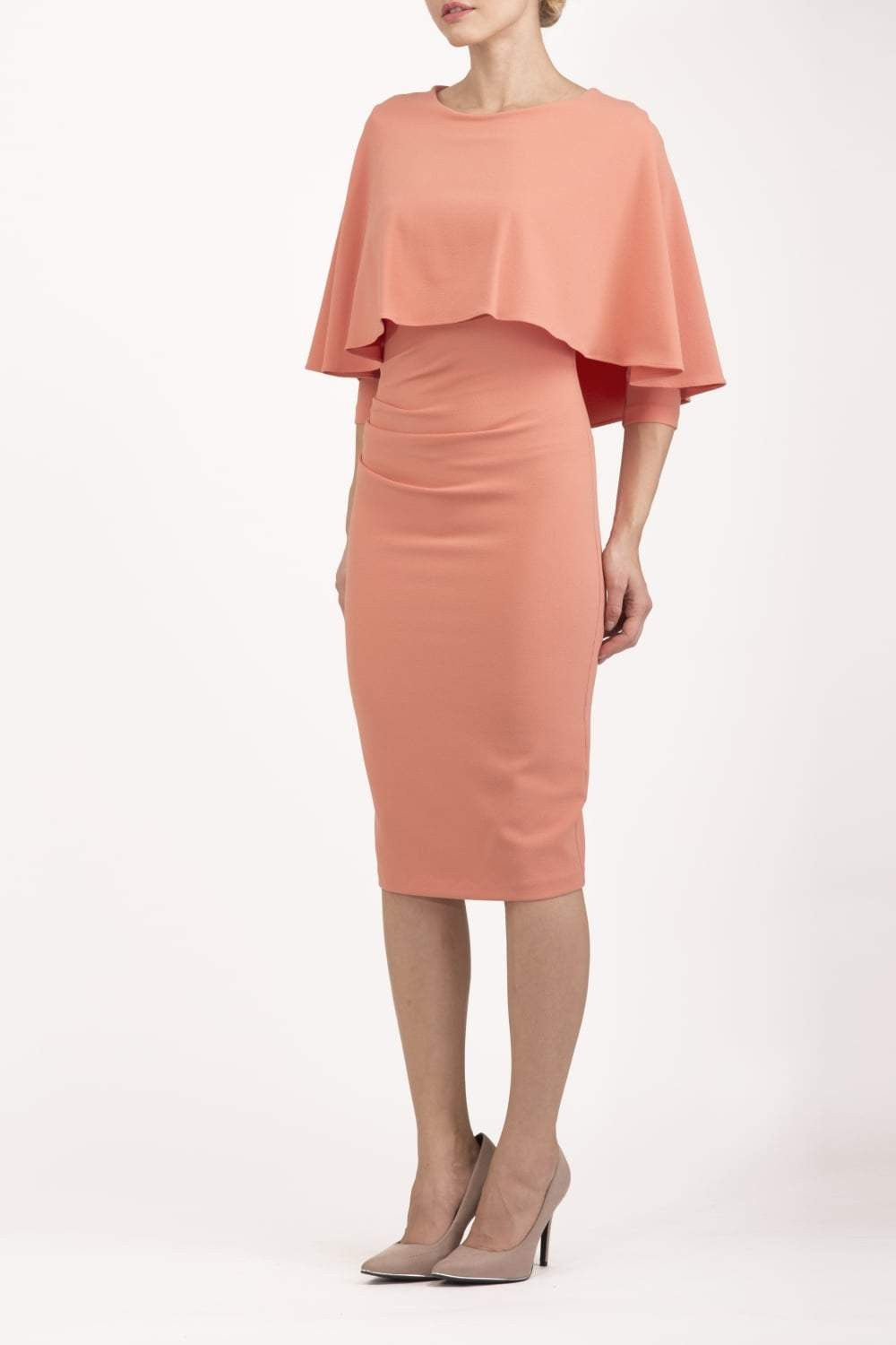 model wearing diva catwalk lizanne pencil-skirt dress with an attached wide cape detail and 3 4 sleeves in colour peach back