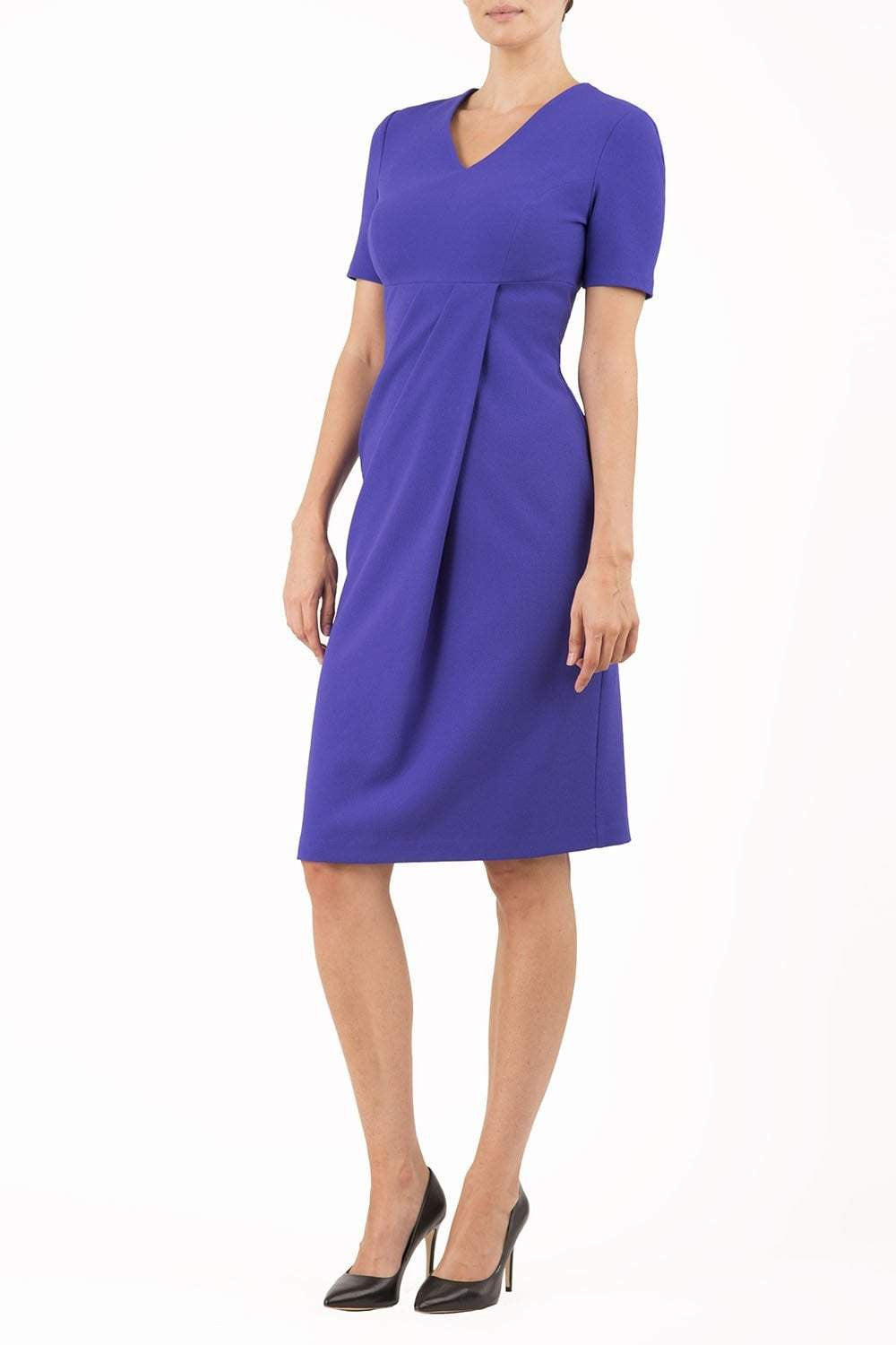 brunette model wearing diva catwalk tregony a-line dress with lowered v-neckline in spectrum indigo and short sleeves front