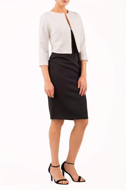 brunette model wearing diva catwalk white sleeved bolero over a black little pencil dress front