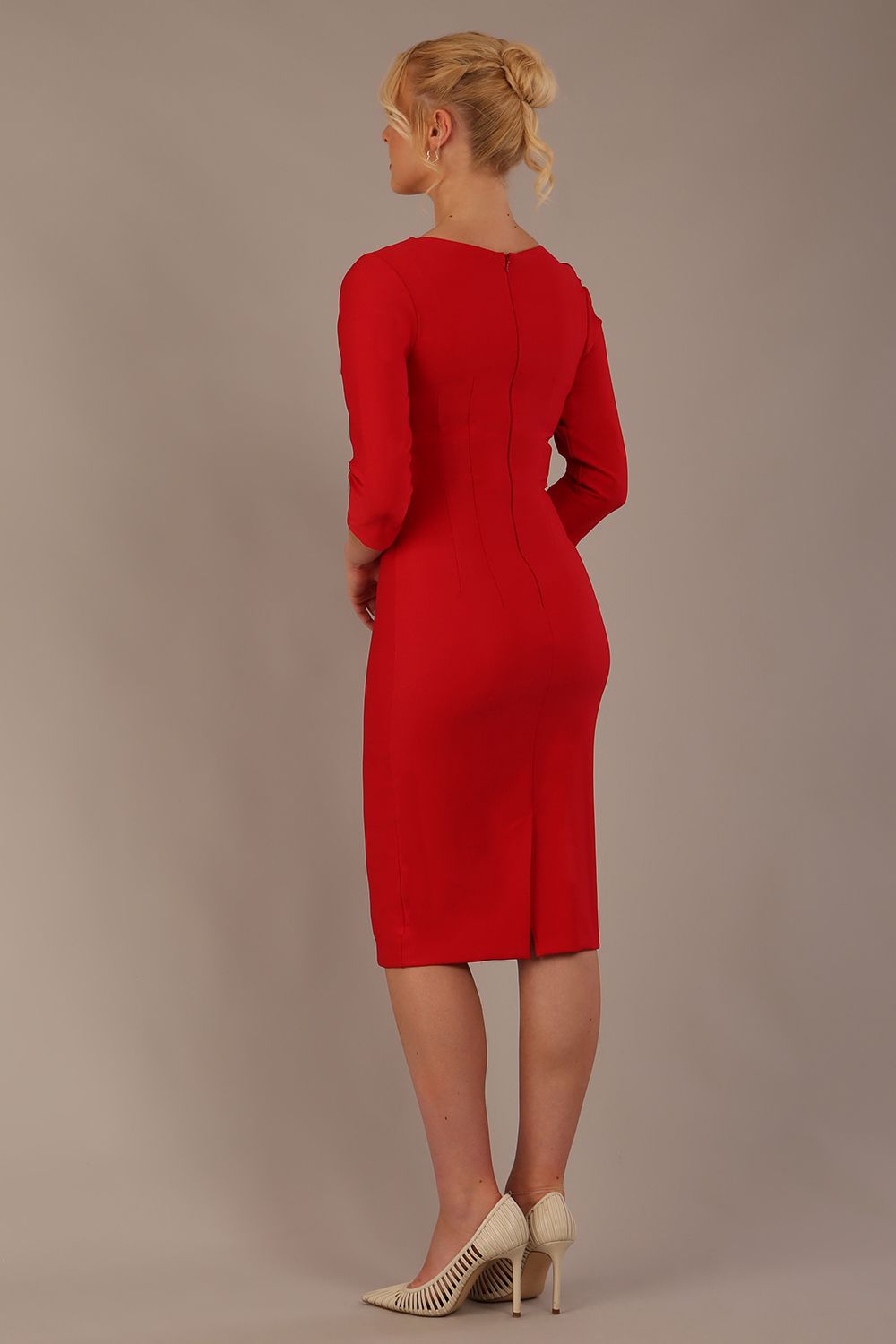 Woman wearing a diva catwalk salsa red Seed Greenwich Sleeved Pencil Dress with a plain background