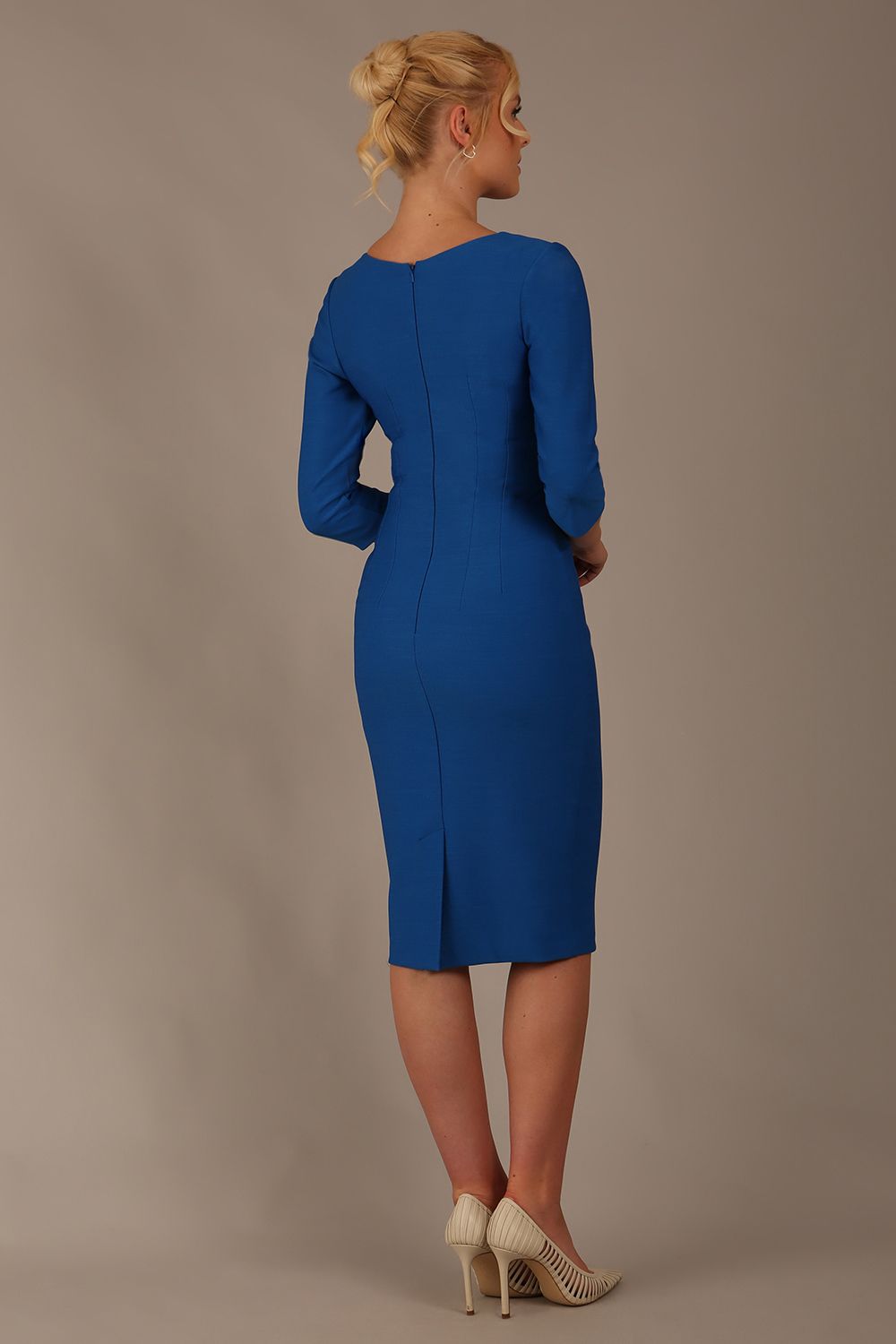 Woman wearing a diva catwalk Seed Greenwich Sleeved Pencil Dress in sapphire blue colour with a plain background close up