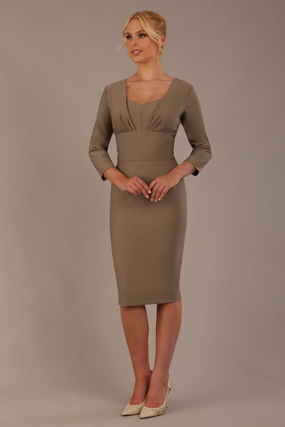 Woman wearing a diva catwalk Seed Greenwich Sleeved Pencil Dress in taupe brown colour with a plain background