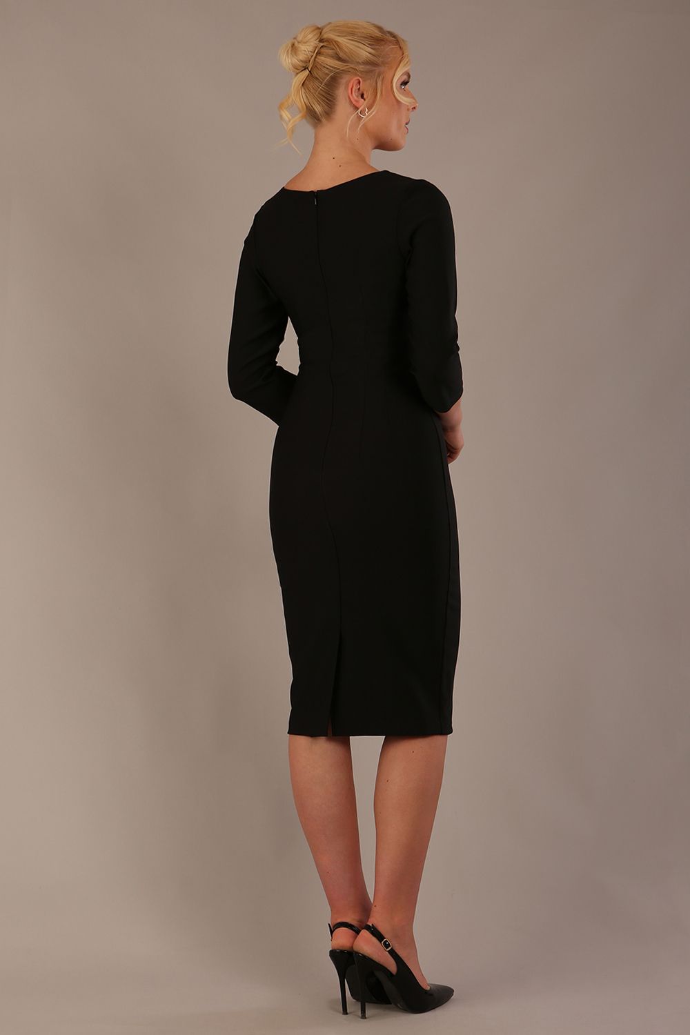 Woman wearing a diva catwalk Seed Greenwich Sleeved Pencil Dress in black colour with a plain background