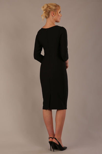 Woman wearing a diva catwalk Seed Greenwich Sleeved Pencil Dress in black colour with a plain background