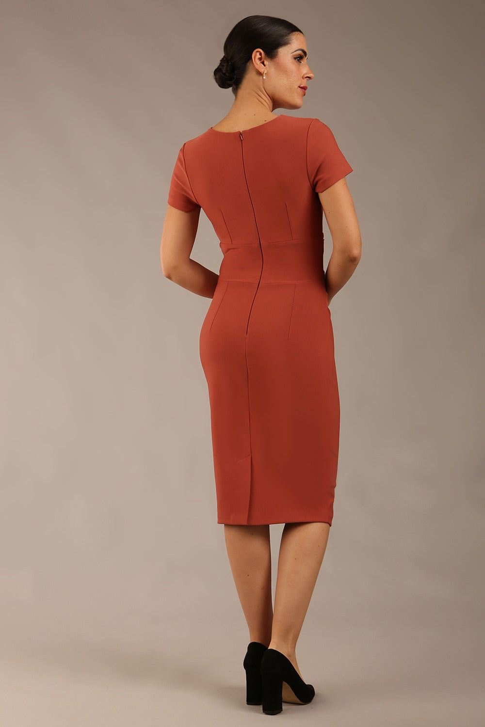 Brunette Model wearing a Diva Catwalk Donna Short Sleeve Pencil Dress with a wide band and pleating across the tummy area and round neckline with v-slit in Marsala Brown front image