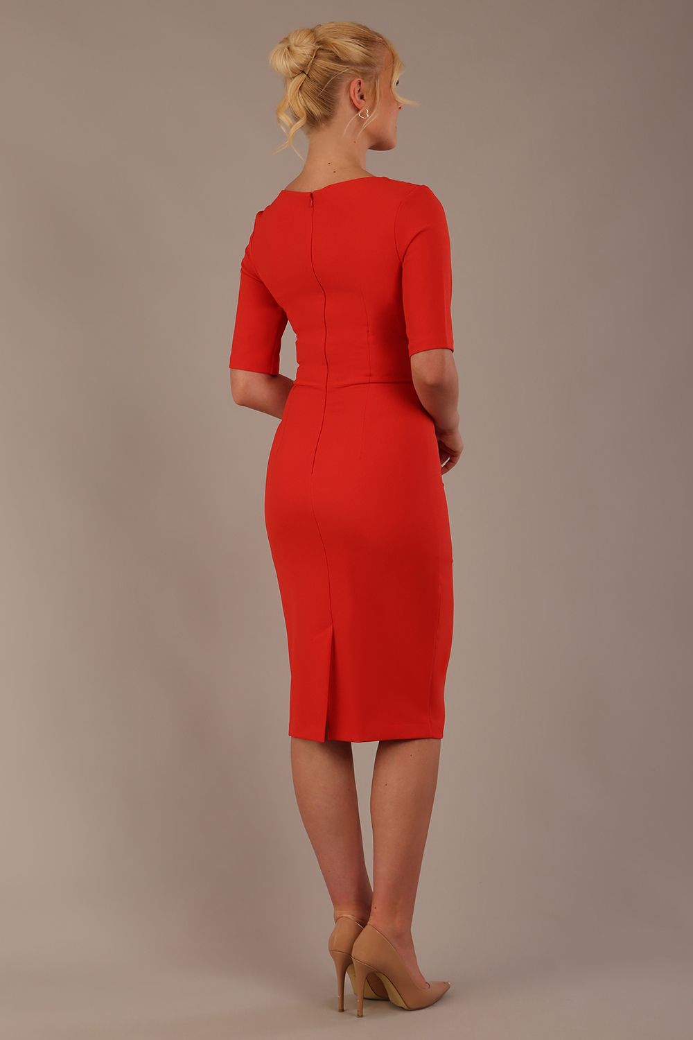 Model wearing the Diva Lynette dress in pencil dress design in fiesta orange front image close up