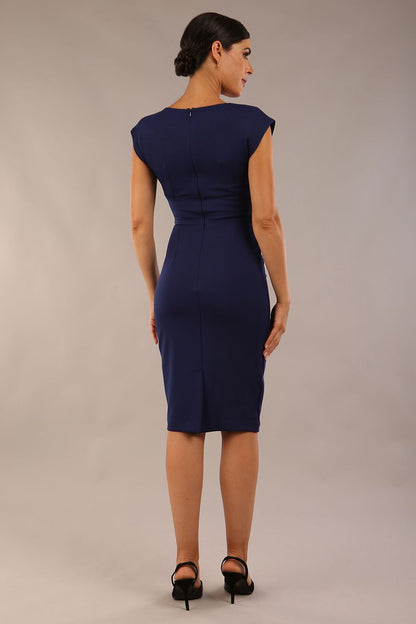 model wearing diva catwalk daphne sleeveless navy blue pencil dress with rounded neckline with split in the middle