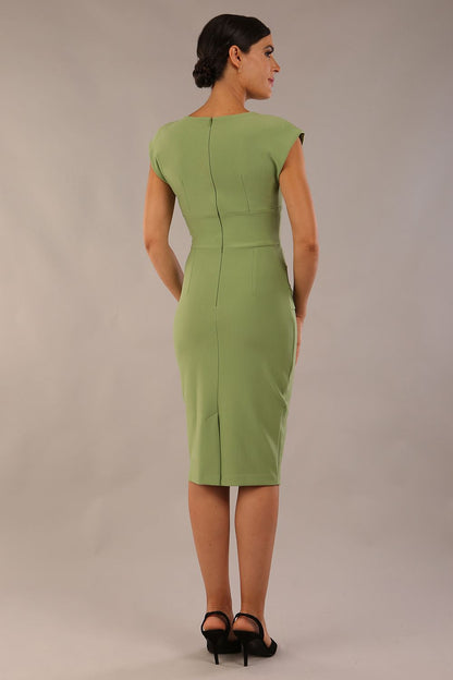 model wearing diva catwalk daphne sleeveless aspen green pencil dress with rounded neckline with split in the middle 