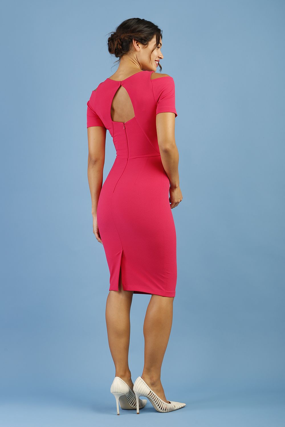 model wearing diva catwalk ruth pencil skirt dress with a keyhole cut in rounded neckline and cold shoulder detail in honeysuckle pink colour front