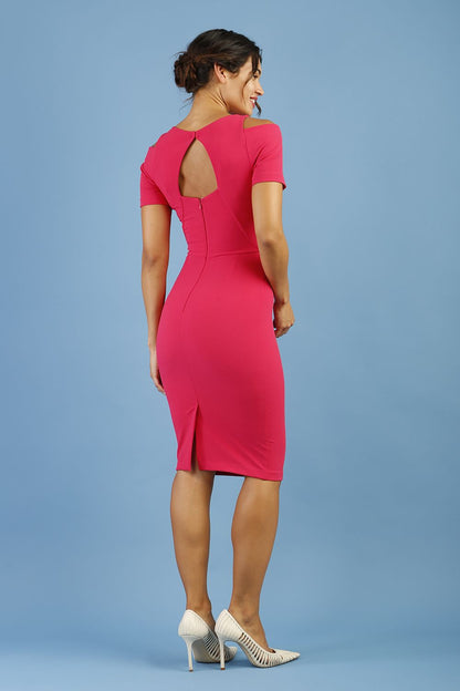 model wearing diva catwalk ruth pencil skirt dress with a keyhole cut in rounded neckline and cold shoulder detail in honeysuckle pink colour front