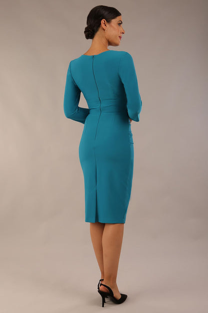 Model wearing the Diva Daphne ¾ Sleeved dress with pleat detail across the hips and ¾ sleeve length in mosaic blue front