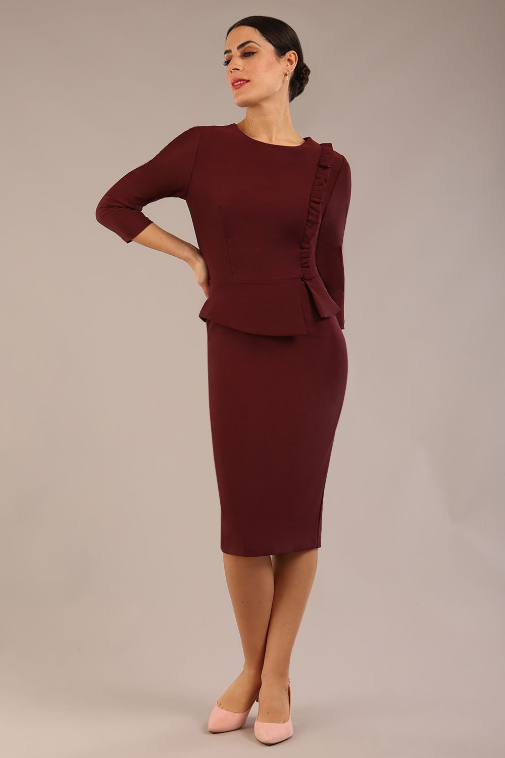 Brunette Model is wearing a three quarter sleeve couture seed pencil dress frill side detail by Diva Catwalk