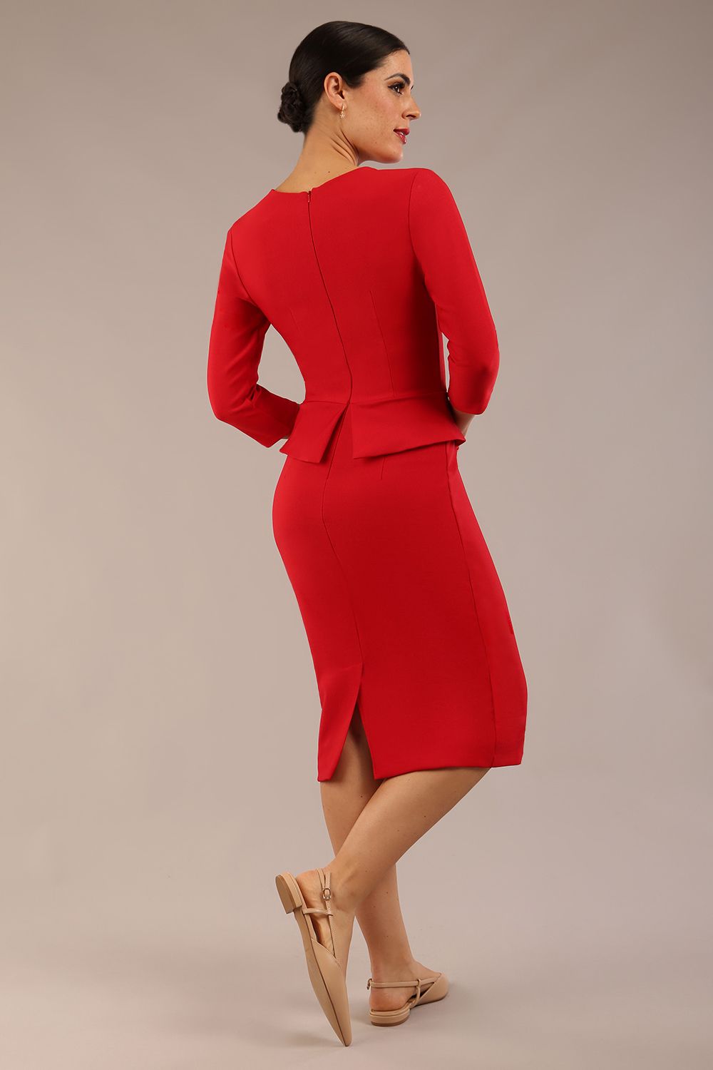 Brunette Model is wearing a three quarter sleeve couture seed pencil dress frill side detail by Diva Catwalk in salsa red