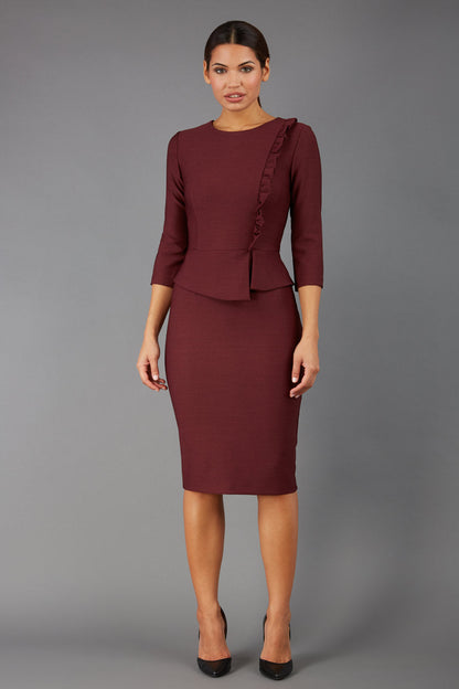Brunette Model is wearing a three quarter sleeve couture seed pencil dress frill side detail by Diva Catwalk