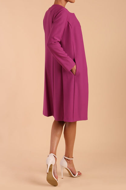 model wearing diva catwalk teal coat with long sleeves and a belt in Orchid Purple front