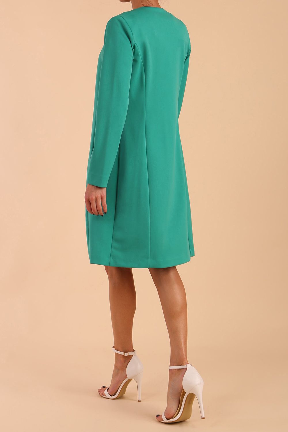 model wearing diva catwalk teal coat with long sleeves and a belt in Emerald Green side