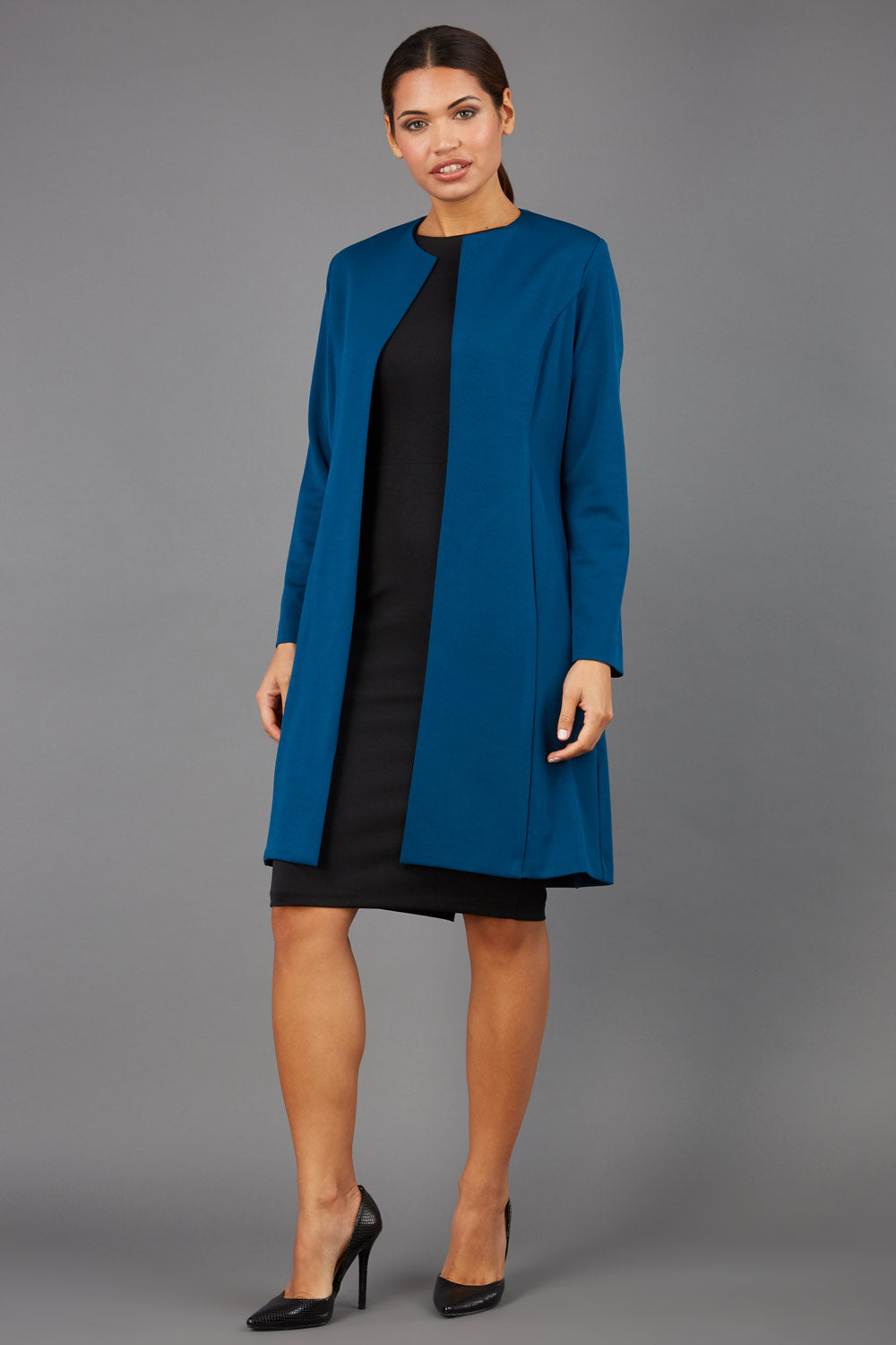 model wearing diva catwalk teal coat with long sleeves and a belt front