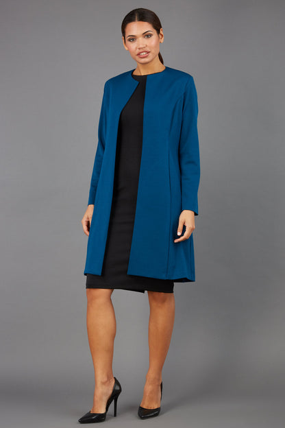 model wearing diva catwalk teal coat with long sleeves and a belt front