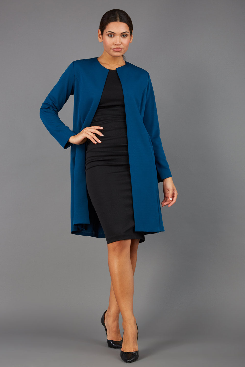model wearing diva catwalk teal coat with long sleeves and a belt front
