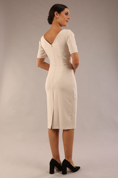 model is wearing diva catwalk seed charlotte pencil plain dress with short sleeve and pleated detail on shoulder in sandy cream front