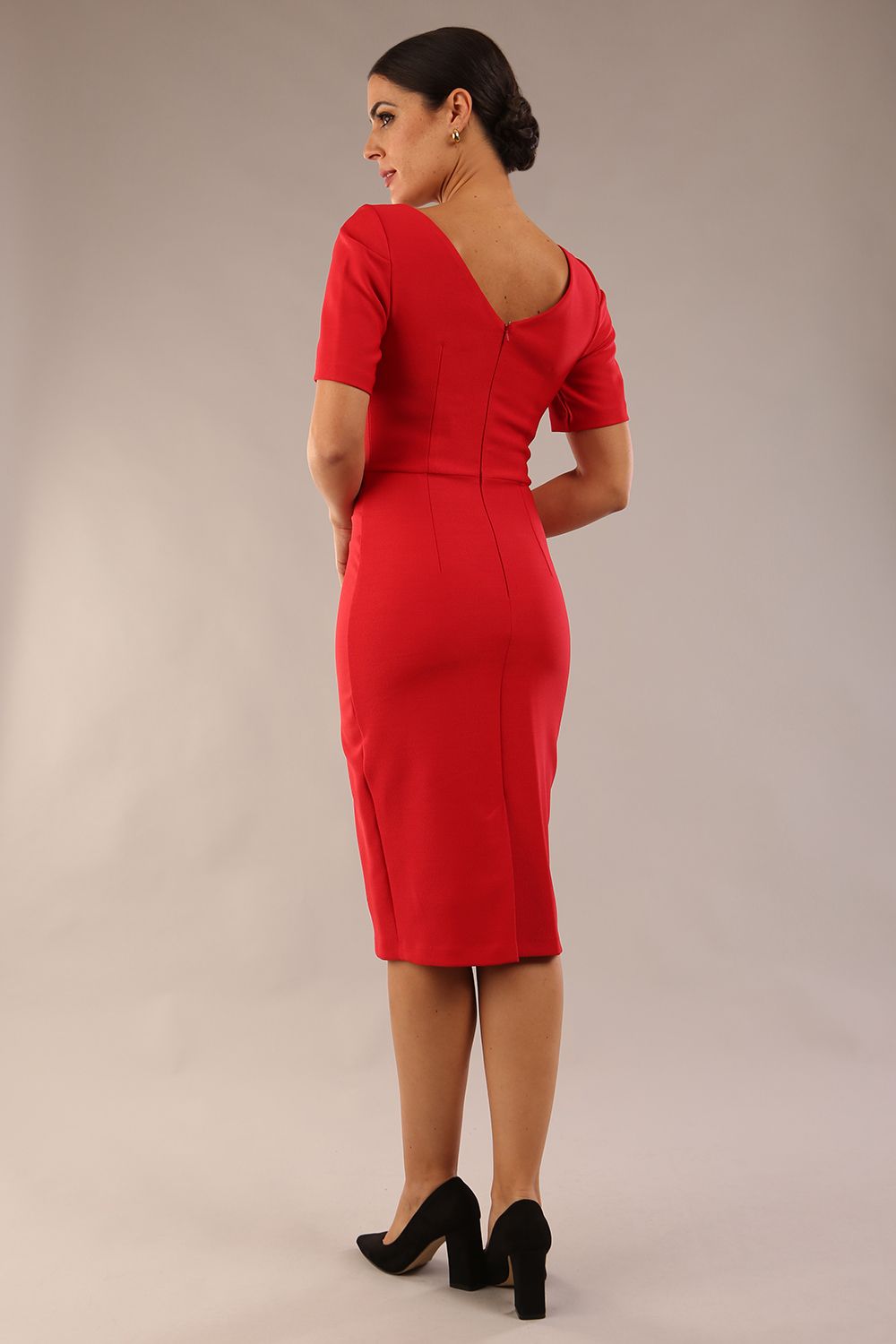 model is wearing diva catwalk seed charlotte pencil plain dress with short sleeve and pleated detail on the shoulder in salsa red colour front