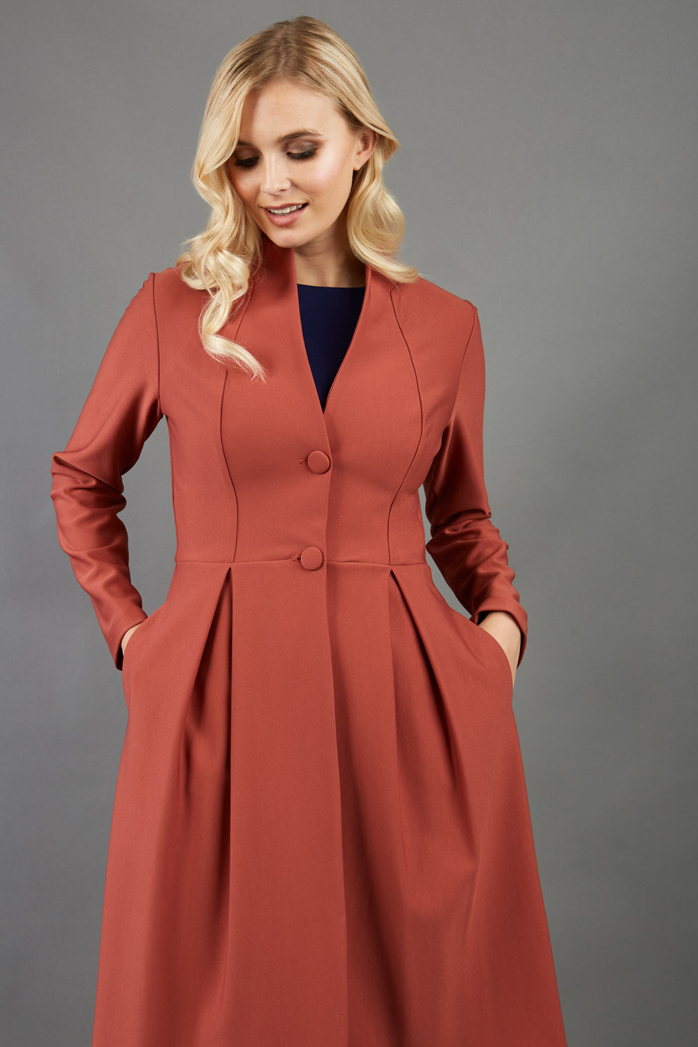 Blonde hair model wearing long sleeve bi stretch Taylor coat in Marsala Brown front image (Marsala Brown)