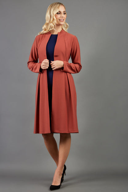 Blonde hair model wearing long sleeve bi stretch Taylor coat in Marsala Brown front image (Marsala Brown)