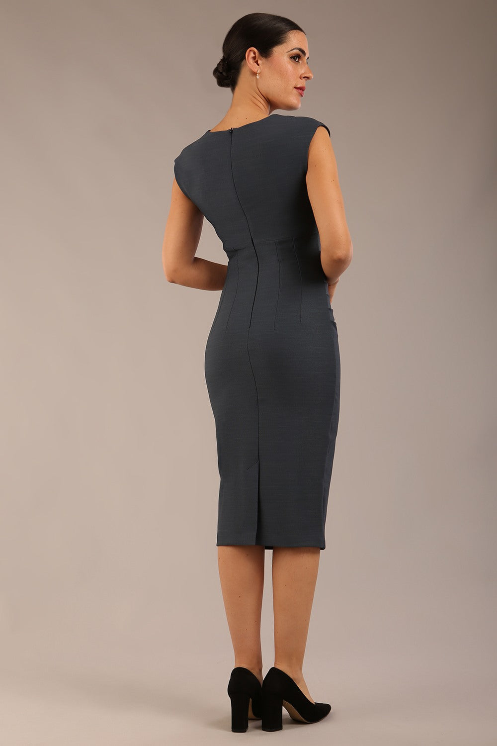 brunette model is wearing a diva catwalk seed Fitzrovia sleeveless pencil dress with round neckline and v-slit and knee length in slate grey colour front image